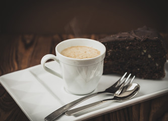 Slice of chocolate cake and cup of coffee