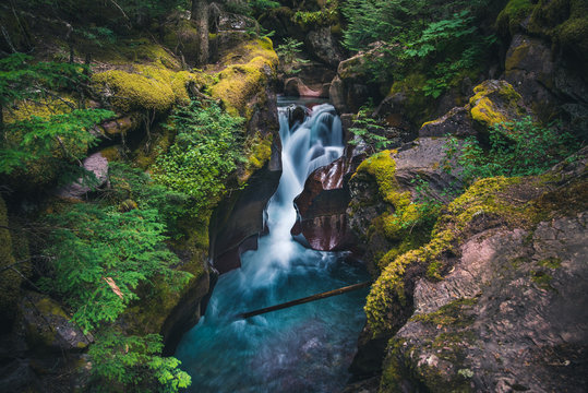 Lush Waterfall Flowing Over Boulders. Glacier National Park, Montana, USA