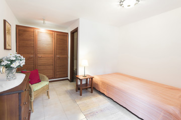 Small apartment room / bedroom with wooden furniture