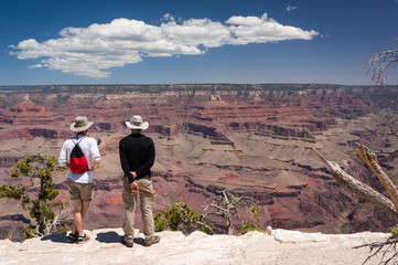 2 tourists watching and admiring the view of Grand Canyon, Arizona, USA