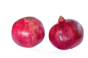 Two ripe pomegranate isolated on a white background.