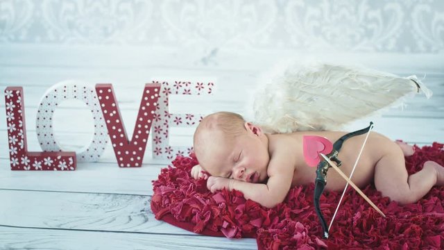 Pretty, sleeping newborn cupid