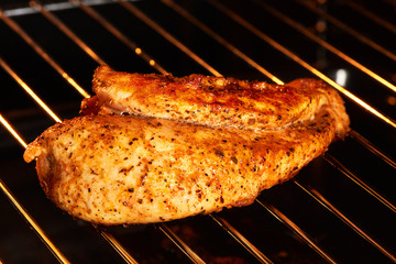 Delicious golden chicken breast on gas grill