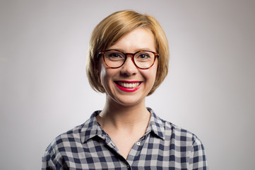 candid portrait of young beautiful and sweet woman in glasses and casual shirt  smiling happy