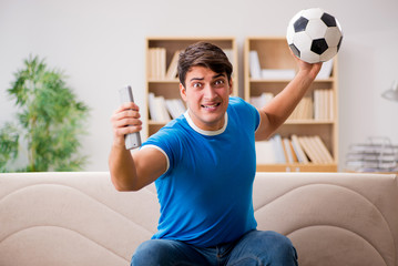 Fototapeta na wymiar Man watching football at home