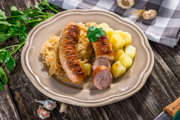 Grilled sausages,  potatoes and sauerkraut