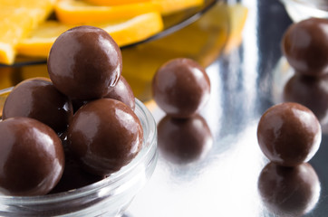 Chocolate candies in a small glass bowl close-up with blur