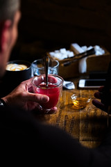 Man's hands holding cup of hot red tea