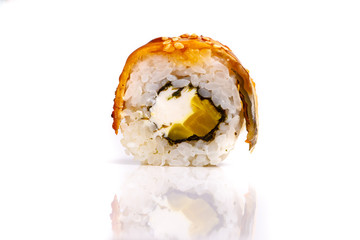 Japanese roll rice, nori, avocado, eel sauce. Close-up on white