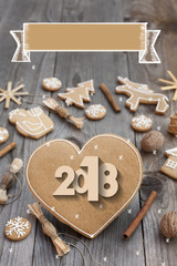 Christmas heart shaped gingerbread background. 2018 Winter holidays atmosphere. Snoflakes. Hand drawn ribbon for copy.Perfect for greeting cards, flyers, etc.Space for copy