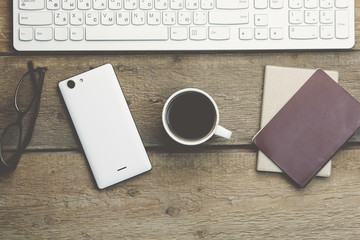 keyboard,phone and passport on table