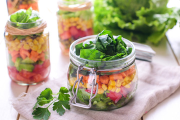 Homemade healthy salads with vegetables in jar
