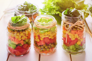 Fototapeta na wymiar Homemade healthy salads with vegetables in jar