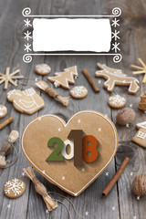 Christmas heart shaped gingerbread background. 2018 Winter holidays atmosphere. Snoflakes. Hand drawn ribbon for copy.Perfect for greeting cards, flyers, etc.Space for copy