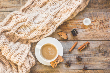 Christmas muffler with cup of cocoa wooden background top view