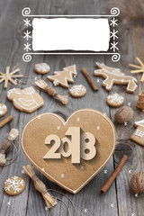 Christmas heart shaped gingerbread background. 2018 Winter holidays atmosphere. Snoflakes. Hand drawn ribbon for copy.Perfect for greeting cards, flyers, etc.Space for copy