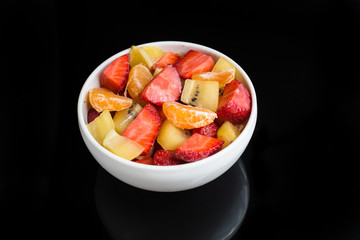 ftuits salad on the black background.