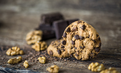 Fototapeta premium Chocolate Chip Cookies and Walnuts on Wooden Rustic Background