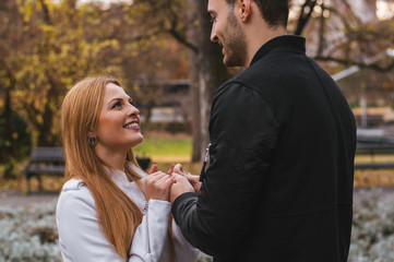 Fototapeta premium She telling something to him, both are smiling. The couple in lo