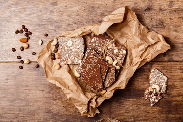 Chocolate and nuts over wooden background. Above.