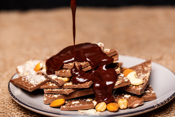 Hot chocolate pouring on candies in white plate  sackcloth.