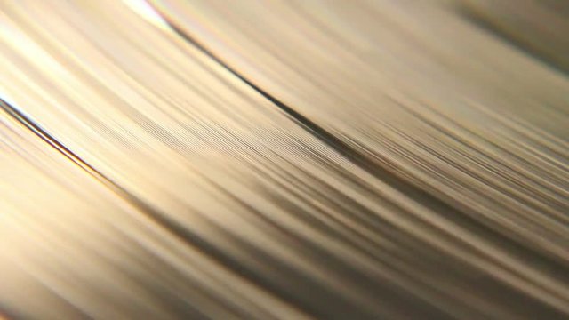 Macro shot of a vinyl sic spinning with its retro grooves. Filmed in a nice romantic light