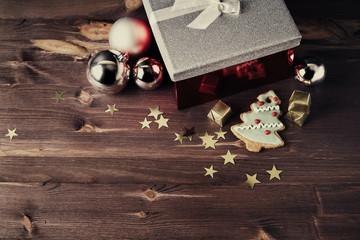 Christmas gift and balls on a wooden table. New Year toy. Christmas concept. Snowflakes. Black background.