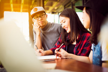 Team group freelancer are brainstroming and talking at coffee shop cafe. Feeling funny and happy.