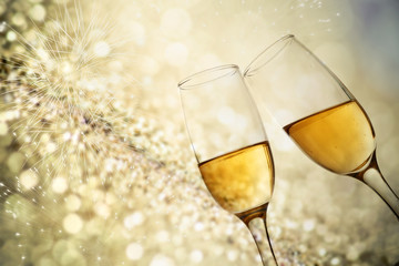 champagne glasses against holiday lights