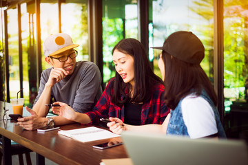 Team group freelancer are brainstroming and talking at coffee shop cafe. Feeling funny and happy.