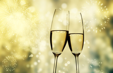 champagne glasses against holiday lights