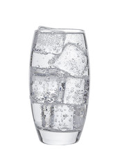 Glass of cold sparkling water with ice cubes