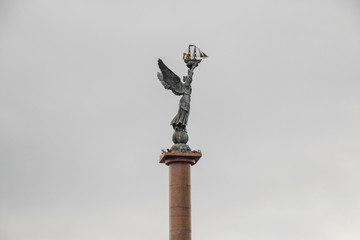 Woman angel on top of the stele. Column with angel. Woman with wings monument. Stella the city of Novorossiysk.