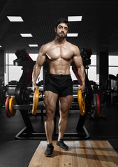 Naklejka na ściany i meble Muscular athletic bodybuilder fitness model