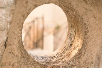 Looking through a mill stone at the Cardo area in the Old City of Jerusalem