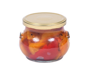 Fire roasted yellow and red peppers in jar isolated on white background