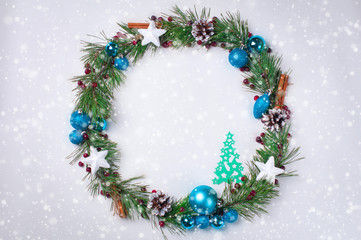 Fototapeta na wymiar Christmas decoration wreath pine branches cones Christmas balls paper Christmas trees white background