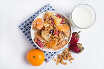 granola with ftuits salad on the white background.