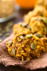 Pumpkin and oatmeal drop cookies with pumpkin seeds on top, photographed with natural light (Selective Focus, Focus one third into the image)
