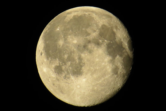 Almost full moon with lots of craters in a dark sky