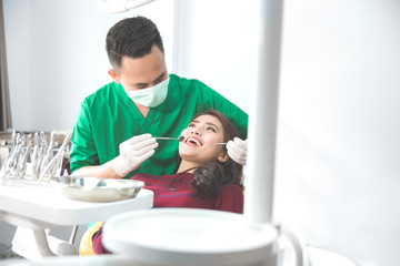 dentist taking care of female patient