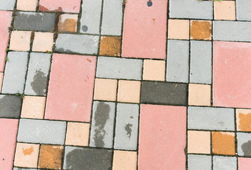 Brick floor , different colored bricks put together.