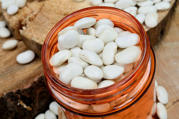 white beans in jar on table