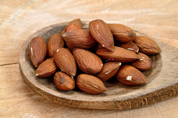 almond in spoon on table