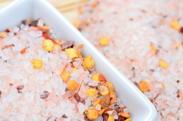 Fototapeta na wymiar pink salt with chili seed on table
