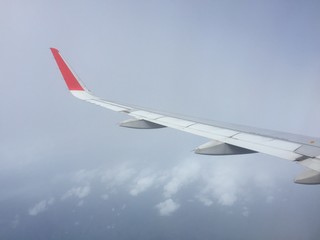 View of clouds from the airplane.Aerial view of cloud and blue sky with wing's airplane.Traveling and journey concept.