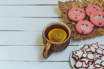 cup of hot tea with lemon and Homemade cookies on white wooden background