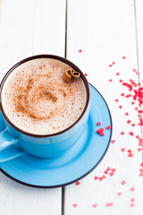 cocoa in a mug and red hearts view from above
