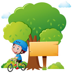 Obraz na płótnie Canvas Park scene with boy riding bike