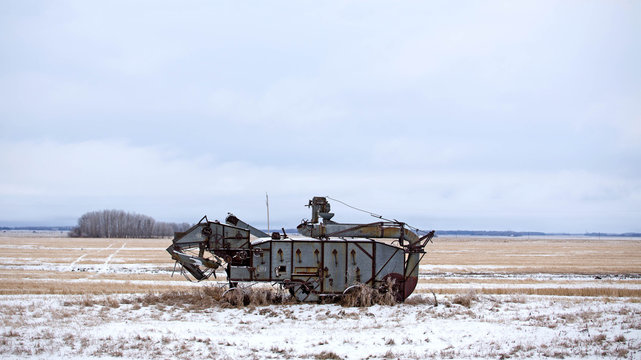 Vintage threshing machine from the 1940s in a rural agriculture landscape